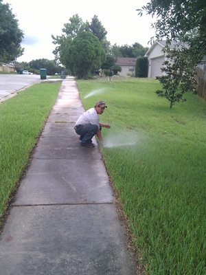 a technician is adjusting the sprinkler head