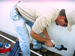 a contractor is replacing a broken pipe with a new one